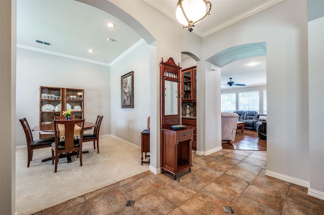 417 Fox Trl, Allen, TX 75002 - dining area featuring arched walkways, crown molding, baseboards, light stone finish floors, and ceiling fan