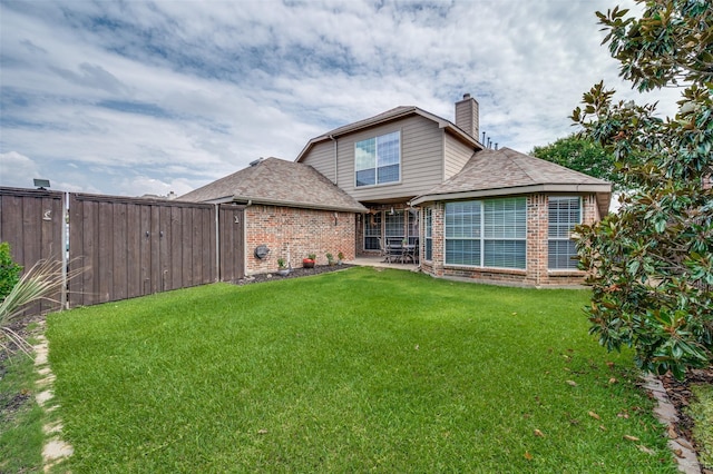 417 Fox Trl, Allen, TX 75002 - back of property with brick siding, a chimney, a patio area, and roof with shingles