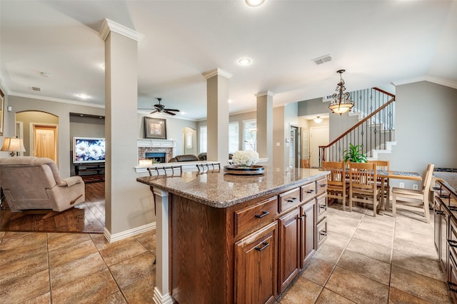 417 Fox Trl, Allen, TX 75002 - kitchen featuring open floor plan, a ceiling fan, ornate columns, a fireplace, and crown molding