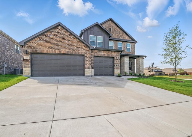 809 Vineyard Way, Forney, TX 75126 - view of front of home with central AC unit, driveway, a front yard, board and batten siding, and brick siding