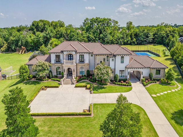 1545 Silver Creek Cir, Lucas, TX 75002 - mediterranean / spanish-style home featuring a tiled roof, stone siding, stucco siding, and a balcony