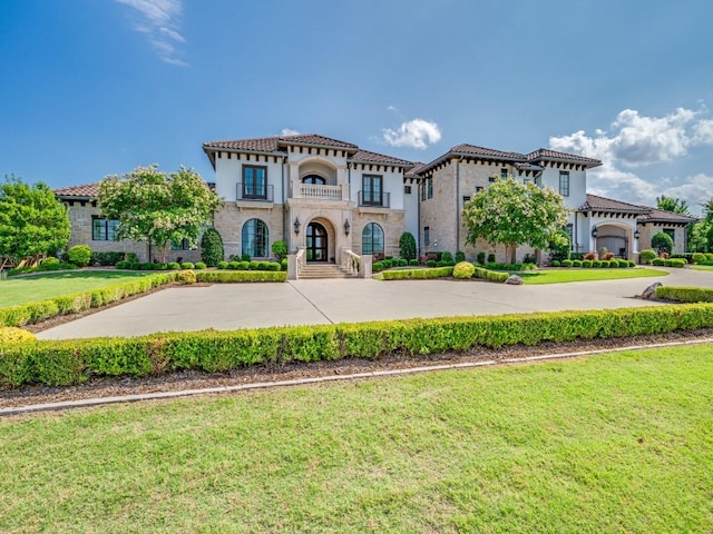 1545 Silver Creek Cir, Lucas, TX 75002 - mediterranean / spanish home featuring a front yard, a tile roof, curved driveway, and stucco siding