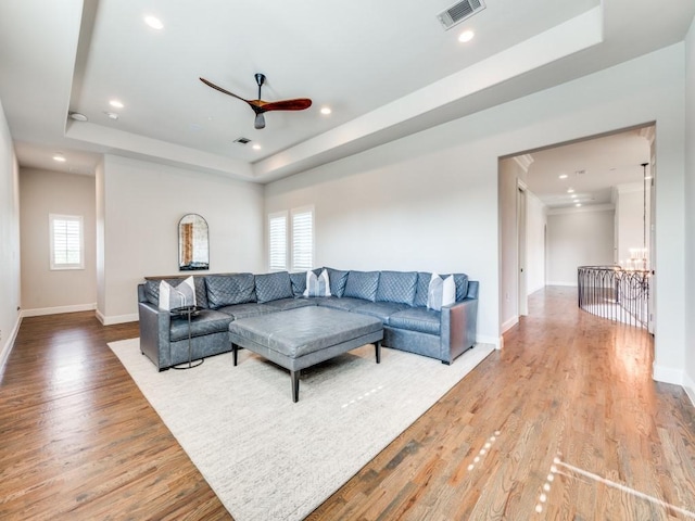 1545 Silver Creek Cir, Lucas, TX 75002 - living room with a raised ceiling, wood finished floors, a chandelier, baseboards, and a ceiling fan