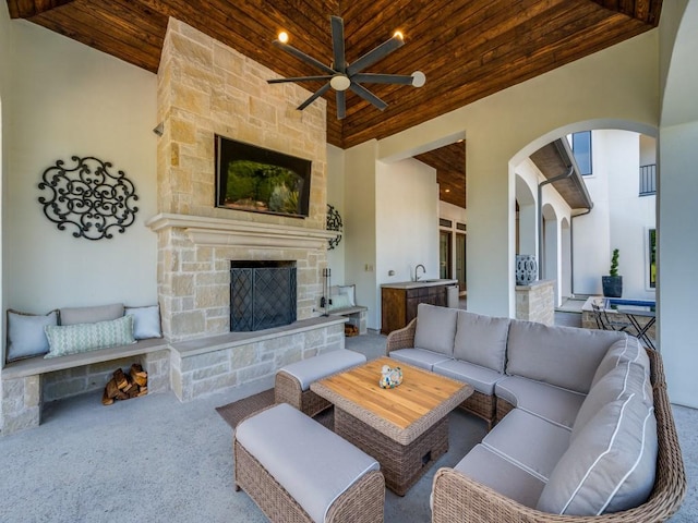 1545 Silver Creek Cir, Lucas, TX 75002 - carpeted living area featuring arched walkways, wooden ceiling, ceiling fan, an outdoor stone fireplace, and a towering ceiling
