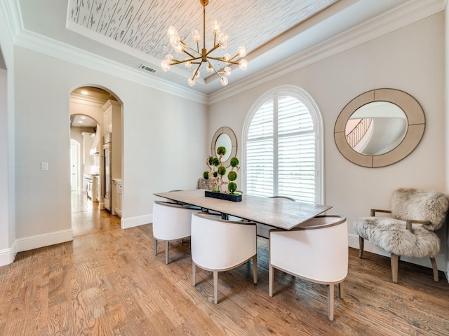 1545 Silver Creek Cir, Lucas, TX 75002 - dining space with a raised ceiling, arched walkways, a chandelier, light wood finished floors, and baseboards