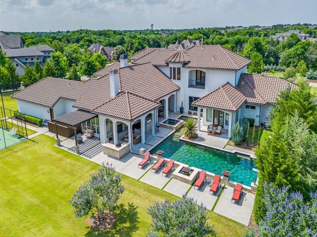 1545 Silver Creek Cir, Lucas, TX 75002 - rear view of house with stucco siding, a tile roof, a pool with connected hot tub, a patio, and outdoor lounge area