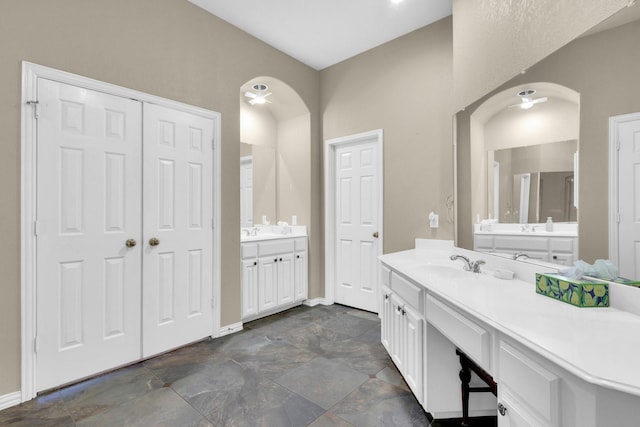 8 Calloway Ct, Mansfield, TX 76063 - bathroom featuring two vanities, baseboards, ceiling fan, and stone finish flooring