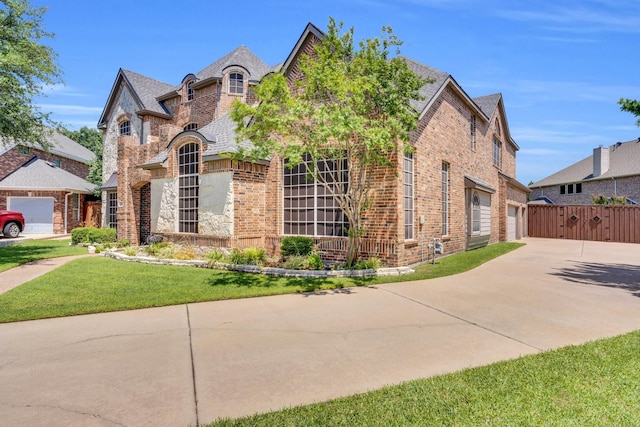 8 Calloway Ct, Mansfield, TX 76063 - french provincial home featuring brick siding, concrete driveway, a front lawn, and a garage