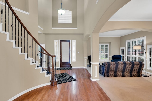 8 Calloway Ct, Mansfield, TX 76063 - entrance foyer featuring wood finished floors, arched walkways, baseboards, stairway, and a towering ceiling