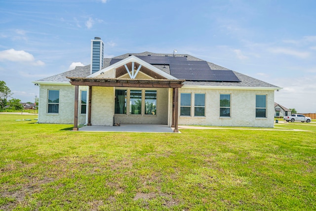 1610 Ryder Lee Ln, Waxahachie, TX 75165 - rear view of house featuring a patio area, brick siding, solar panels, and a yard