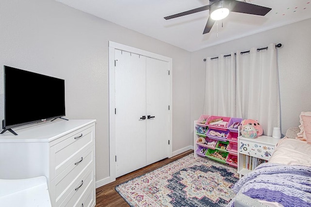 1117 Marcia Ln, Burleson, TX 76028 - bedroom featuring dark wood-style flooring, a closet, a ceiling fan, and baseboards