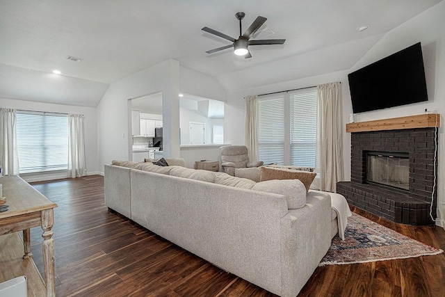 1117 Marcia Ln, Burleson, TX 76028 - living room featuring lofted ceiling, a ceiling fan, a brick fireplace, dark wood-style floors, and baseboards