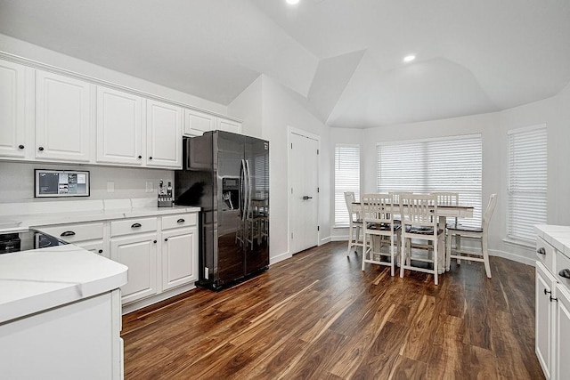 1117 Marcia Ln, Burleson, TX 76028 - kitchen featuring black fridge, vaulted ceiling, white cabinets, baseboards, and light countertops