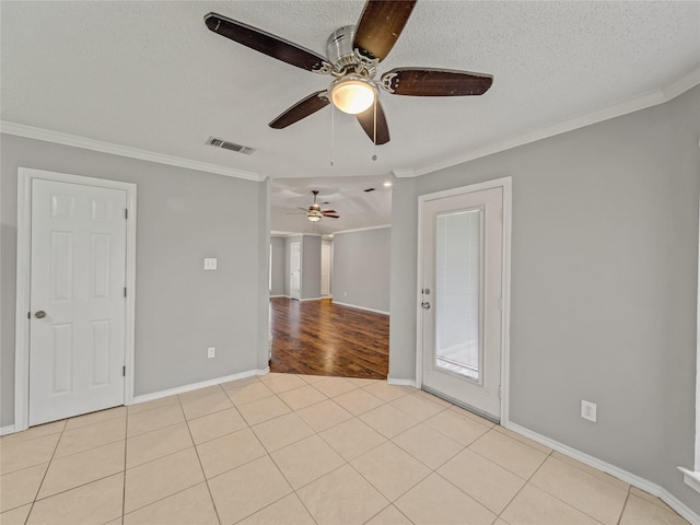 7900 Marsh Ct, Fort Worth, TX 76123 - empty room featuring crown molding, a ceiling fan, baseboards, a textured ceiling, and light tile patterned floors