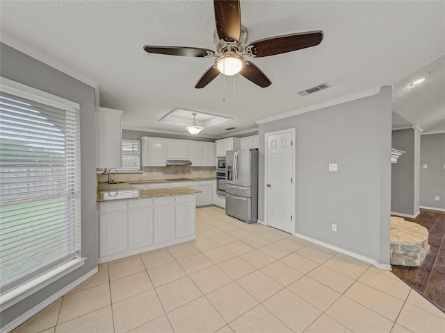 7900 Marsh Ct, Fort Worth, TX 76123 - kitchen featuring stainless steel appliances, ceiling fan, crown molding, white cabinetry, and a peninsula