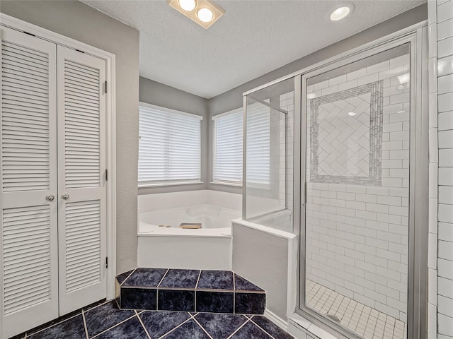 7900 Marsh Ct, Fort Worth, TX 76123 - full bathroom featuring a garden tub, a stall shower, a closet, a textured ceiling, and tile patterned floors