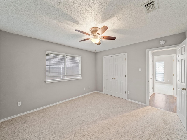 7900 Marsh Ct, Fort Worth, TX 76123 - unfurnished bedroom featuring carpet floors, baseboards, a closet, ceiling fan, and a textured ceiling