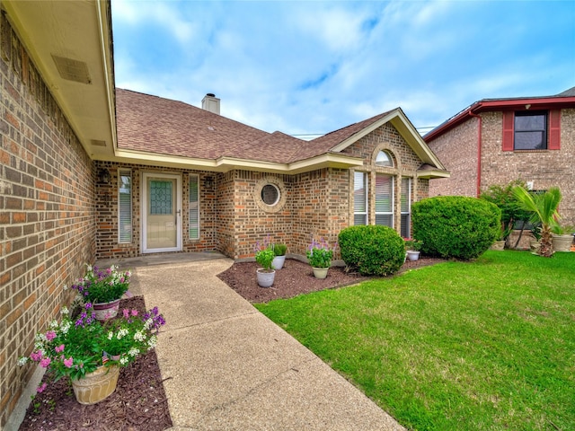 7900 Marsh Ct, Fort Worth, TX 76123 - view of exterior entry with brick siding, a shingled roof, a yard, and a chimney