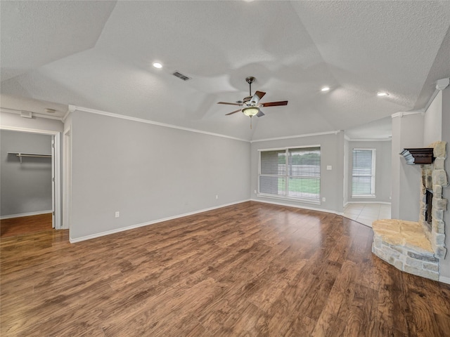 7900 Marsh Ct, Fort Worth, TX 76123 - unfurnished living room with a textured ceiling, vaulted ceiling, ceiling fan, crown molding, and wood finished floors