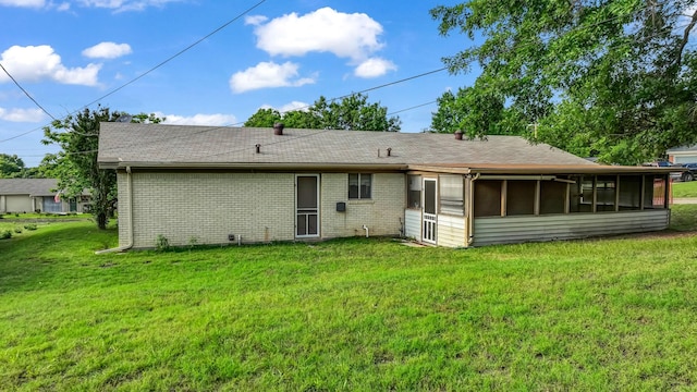 212 E Rentz St, Weatherford, TX 76086 - rear view of property featuring a lawn, a sunroom, and brick siding
