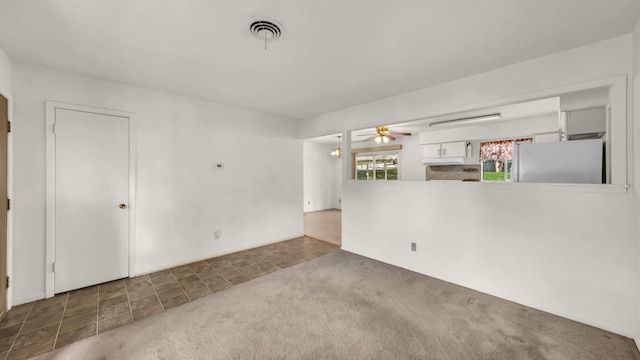 212 E Rentz St, Weatherford, TX 76086 - unfurnished living room with a ceiling fan, carpet flooring, and baseboards