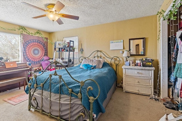 1320 Laredo Dr, Granbury, TX 76048 - carpeted bedroom featuring multiple windows, a textured ceiling, and ceiling fan