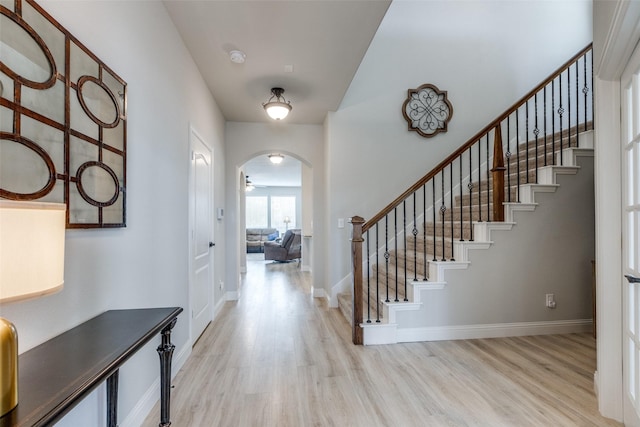 1421 Cedar Creek Dr, Anna, TX 75409 - foyer featuring arched walkways, wood finished floors, stairs, and baseboards