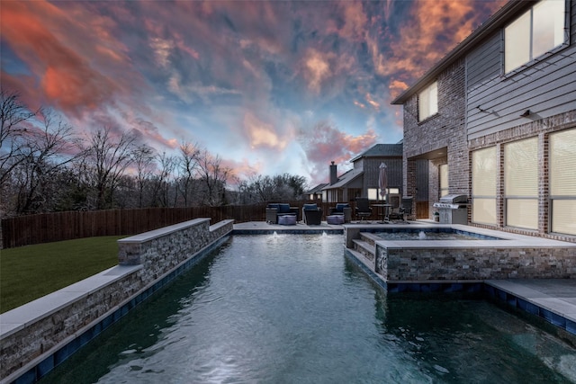 1421 Cedar Creek Dr, Anna, TX 75409 - pool at dusk featuring area for grilling, a pool with connected hot tub, and a patio