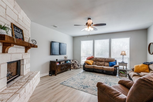 1421 Cedar Creek Dr, Anna, TX 75409 - living area featuring ceiling fan, light wood finished floors, a fireplace, and baseboards