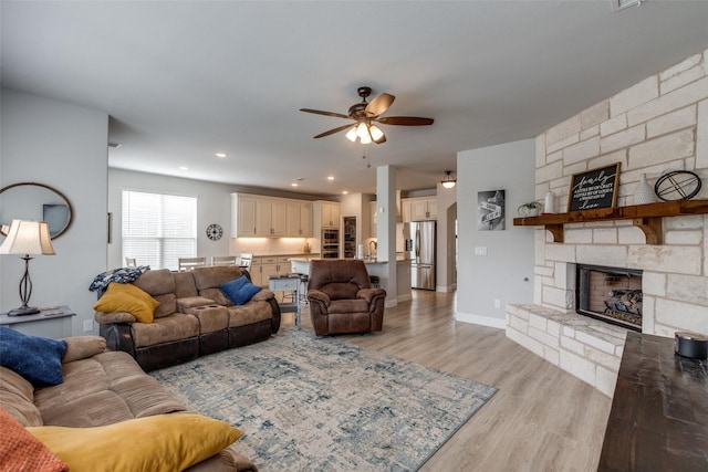 1421 Cedar Creek Dr, Anna, TX 75409 - living room featuring ceiling fan, light wood-style flooring, a fireplace, and baseboards
