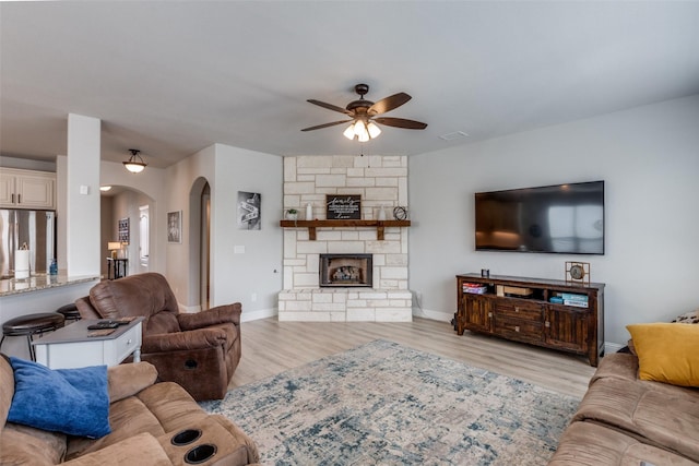 1421 Cedar Creek Dr, Anna, TX 75409 - living room with arched walkways, a ceiling fan, wood finished floors, and baseboards
