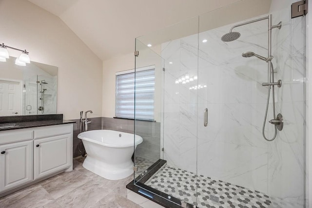 230 Mitchell Blvd, Weatherford, TX 76087 - bathroom with lofted ceiling, a marble finish shower, vanity, a freestanding tub, and tile walls