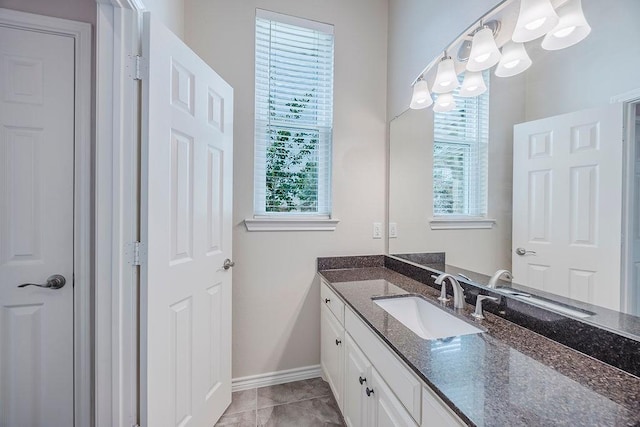 230 Mitchell Blvd, Weatherford, TX 76087 - bathroom featuring vanity, healthy amount of natural light, baseboards, and a chandelier