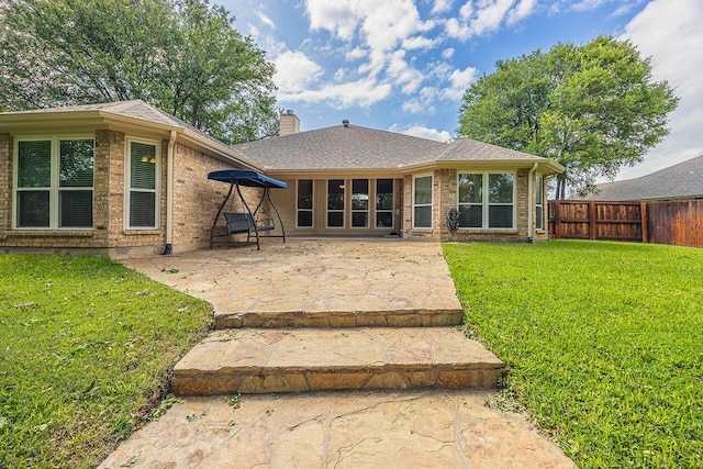 230 Mitchell Blvd, Weatherford, TX 76087 - back of property featuring a patio area, a chimney, brick siding, and roof with shingles