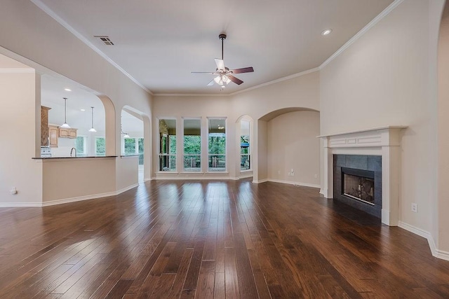 230 Mitchell Blvd, Weatherford, TX 76087 - unfurnished living room featuring a ceiling fan, dark wood-style floors, a tiled fireplace, baseboards, and ornamental molding