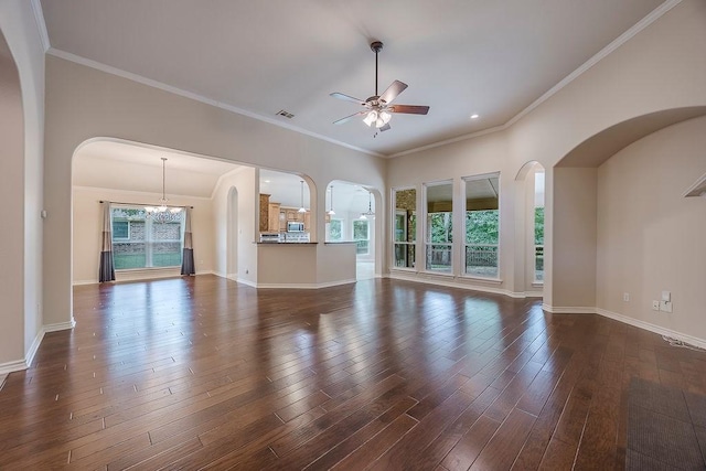230 Mitchell Blvd, Weatherford, TX 76087 - unfurnished living room with a ceiling fan, arched walkways, dark wood-style flooring, baseboards, and crown molding