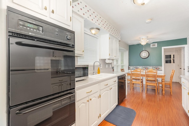 1621 Villanova Dr, Richardson, TX 75081 - kitchen featuring a sink, a ceiling fan, black appliances, white cabinetry, and light countertops