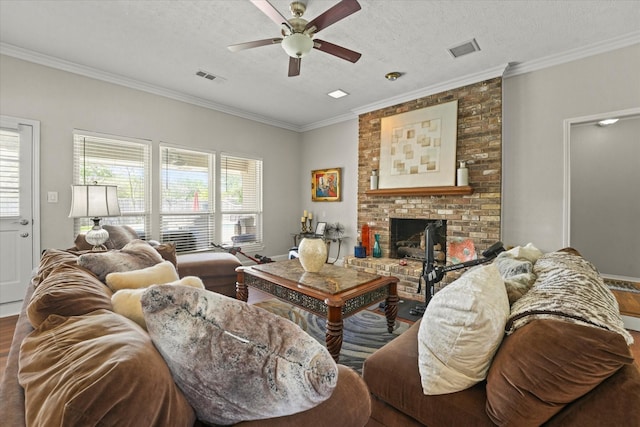 3701 Knob Hill Dr, Plano, TX 75023 - living area featuring ceiling fan, wood finished floors, ornamental molding, a brick fireplace, and a textured ceiling