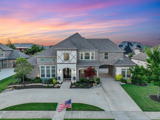 1551 Sweetwater Ln, Prosper, TX 75078 - french country style house featuring stone siding, roof with shingles, and a lawn