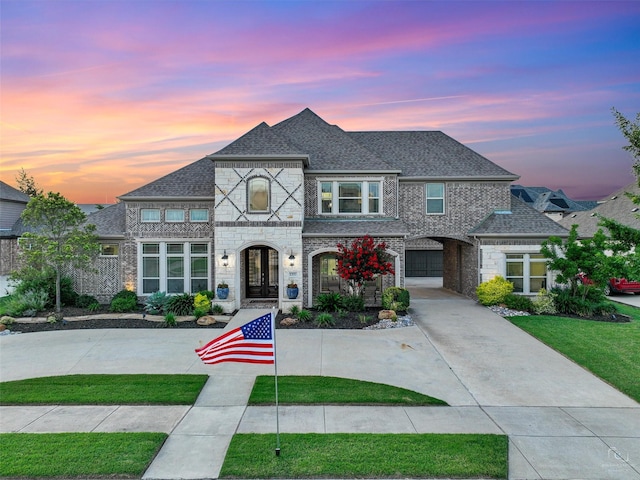 1551 Sweetwater Ln, Prosper, TX 75078 - french country style house featuring french doors, a front lawn, and a shingled roof
