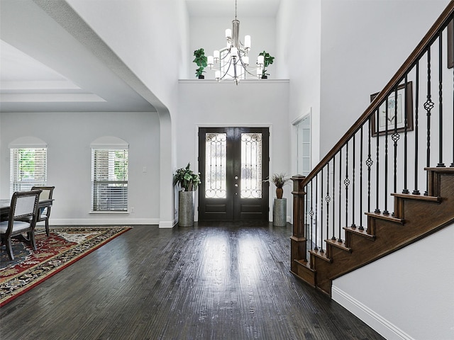 1551 Sweetwater Ln, Prosper, TX 75078 - entryway with a chandelier, dark wood finished floors, stairs, and arched walkways