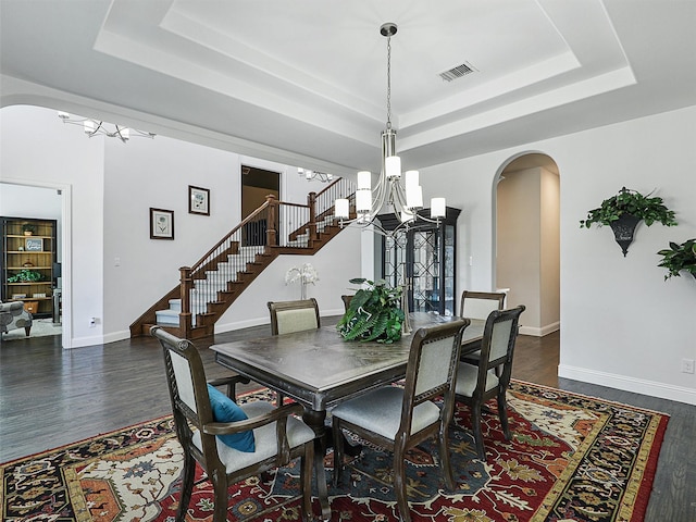 1551 Sweetwater Ln, Prosper, TX 75078 - dining area featuring a chandelier, arched walkways, a raised ceiling, and stairs