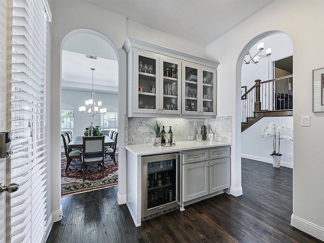 1551 Sweetwater Ln, Prosper, TX 75078 - indoor dry bar with beverage cooler, arched walkways, a chandelier, and decorative backsplash