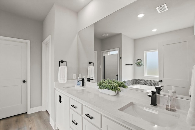 80 Dublin Cir, Gordonville, TX 76245 - bathroom with double vanity, wood finished floors, recessed lighting, a bath, and a stall shower