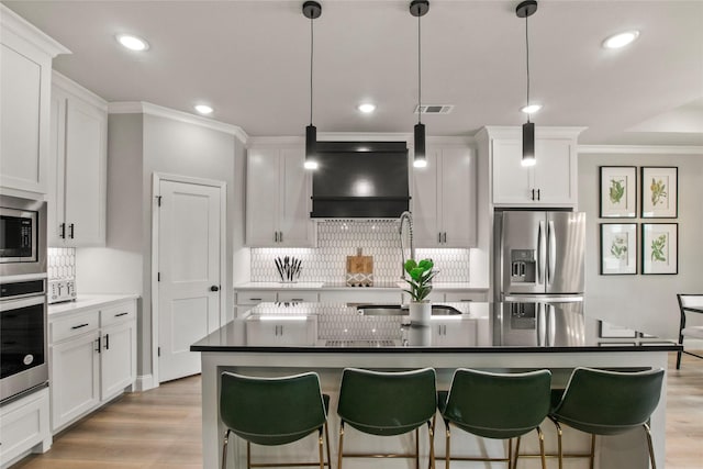 80 Dublin Cir, Gordonville, TX 76245 - kitchen with appliances with stainless steel finishes, exhaust hood, ornamental molding, backsplash, and light wood-type flooring