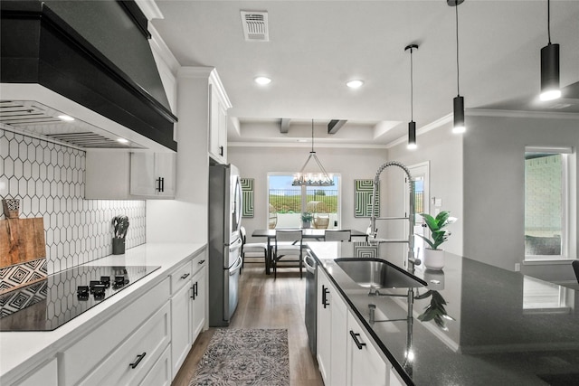 80 Dublin Cir, Gordonville, TX 76245 - kitchen featuring stainless steel appliances, a sink, wall chimney range hood, wood finished floors, and backsplash