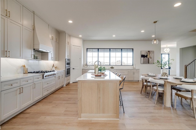 4513 Fair Creek Ter, Fort Worth, TX 76008 - kitchen featuring appliances with stainless steel finishes, recessed lighting, light countertops, a center island, and light wood-style flooring