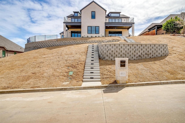 4513 Fair Creek Ter, Fort Worth, TX 76008 - view of front of home featuring a balcony, stairs, and stucco siding