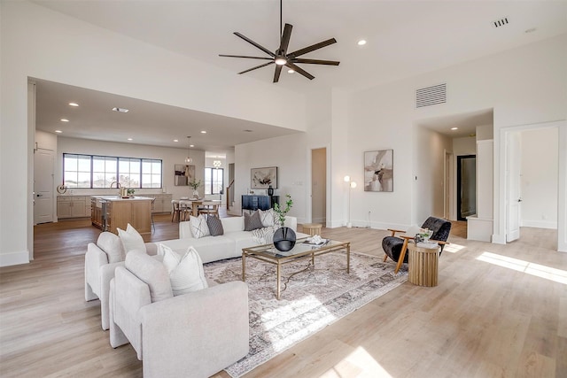 4513 Fair Creek Ter, Fort Worth, TX 76008 - living room featuring ceiling fan, light wood-style floors, baseboards, recessed lighting, and a high ceiling