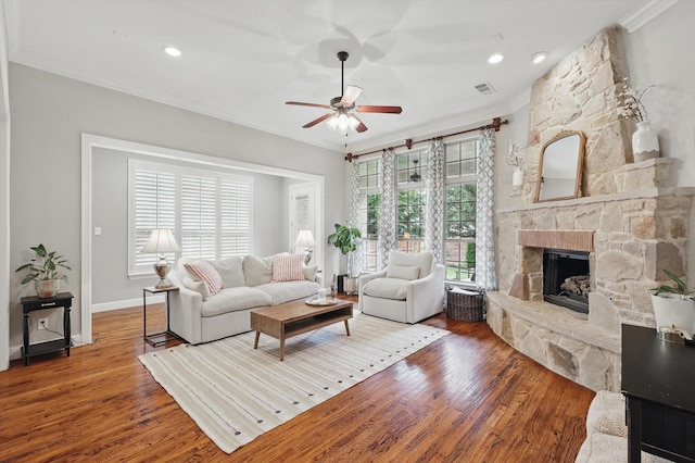 9008 Cypress Creek Rd, Lantana, TX 76226 - living room featuring crown molding, ceiling fan, wood finished floors, a stone fireplace, and baseboards